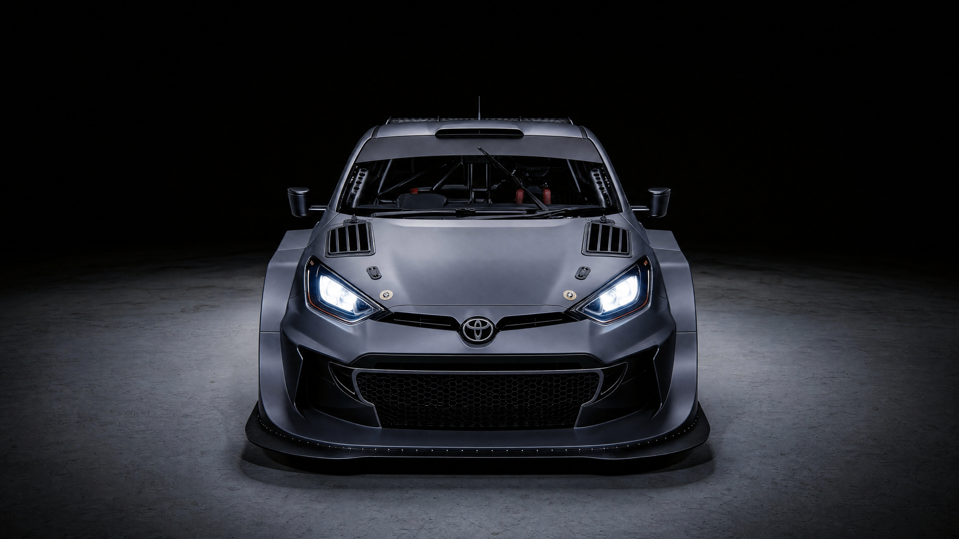 Finished Toyota Yaris GR rally build — head-on view under studio lighting