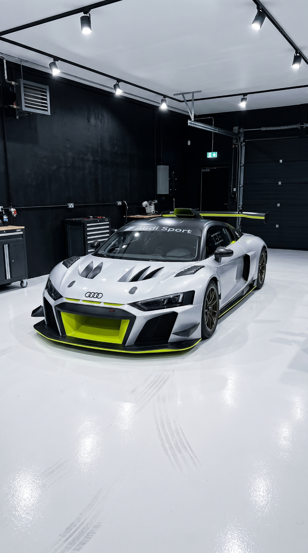 White Audi R8 GT2 with lime-green accents parked in the NorthSea Dynamics shop